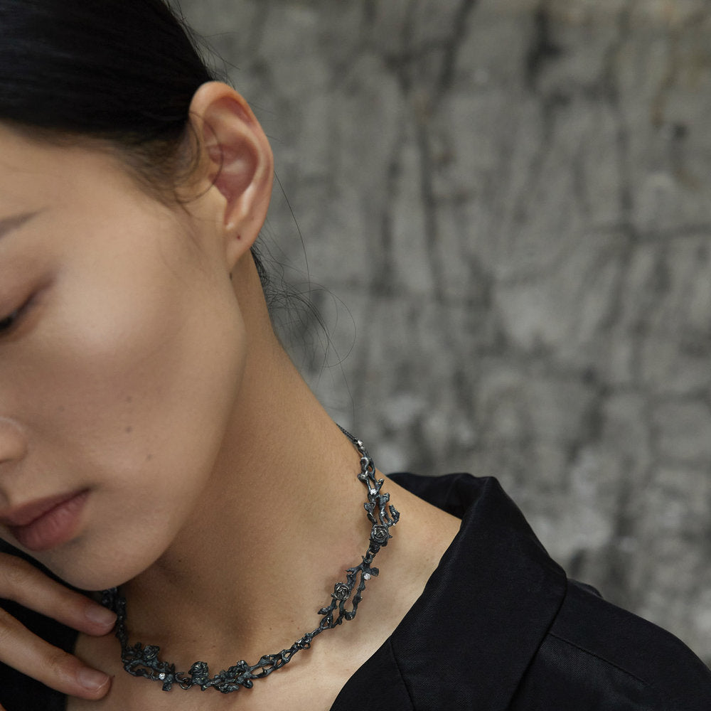 Woman wearing an unique black floral choker