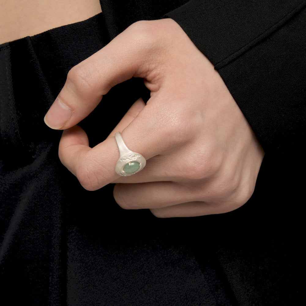 Hand wearing a Heart Ring against a black background