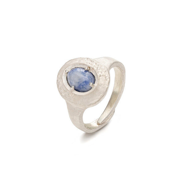 Silver ring with a blue gemstone on a white background