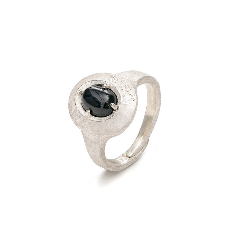 Silver ring with a black gemstone on a white background