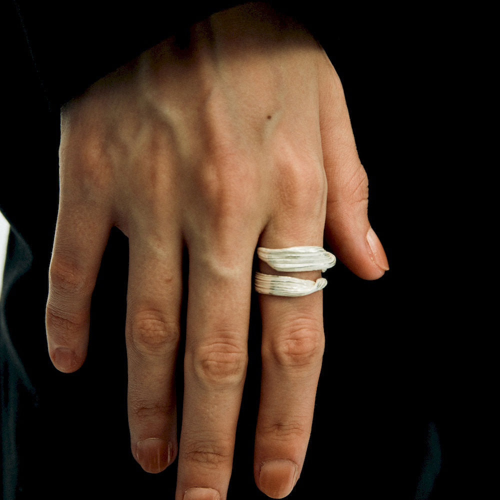 Hand wearing a silver white adjustable ring