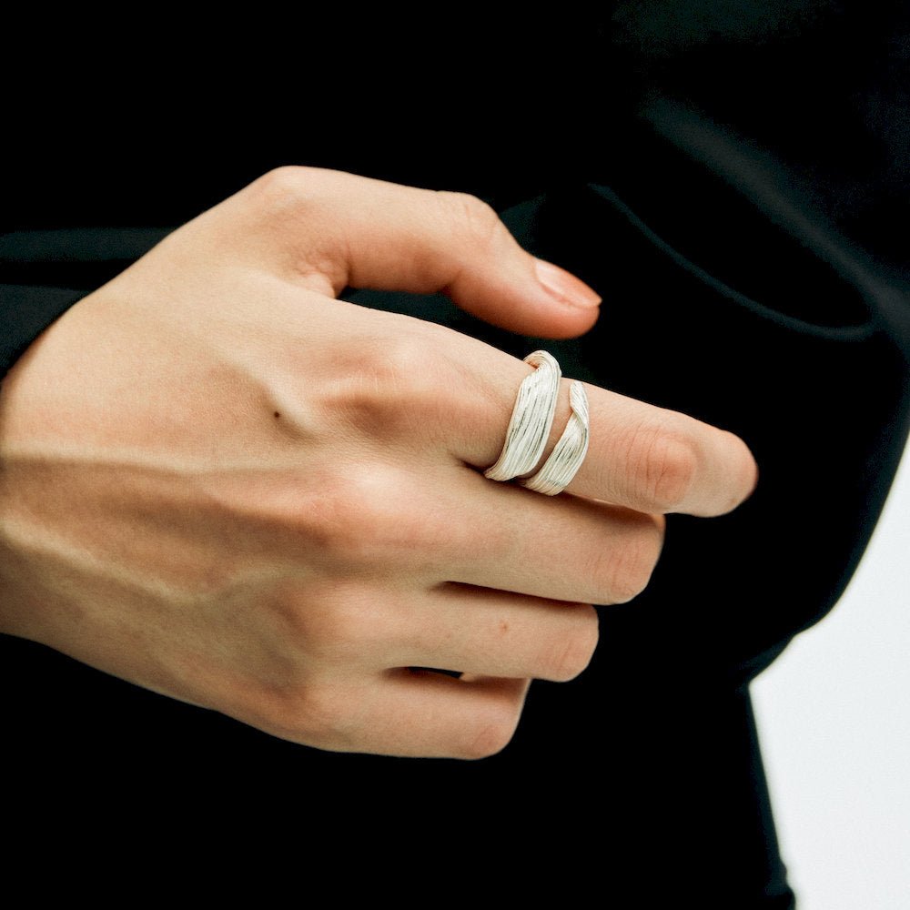 Hand wearing a 925 Sterling Silver ring from Linework Collection