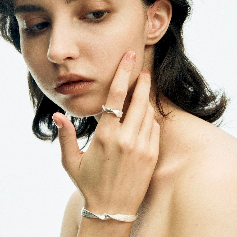 Woman wearing a set of a silver ring and bracelet from lifework collection