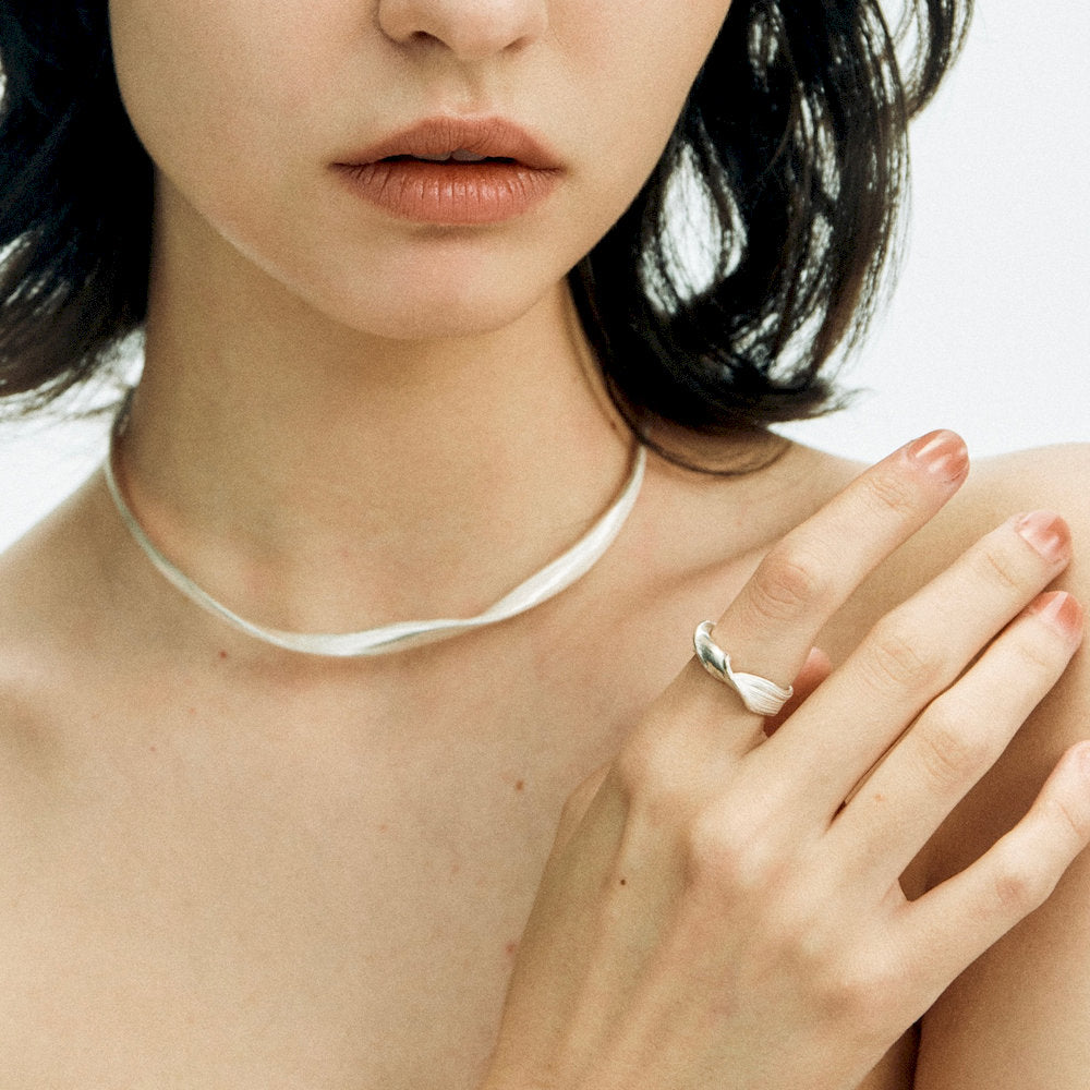 Close-up of a woman’s hand wearing a sculptural silver ring from the Linework Collection by Echo & Co.