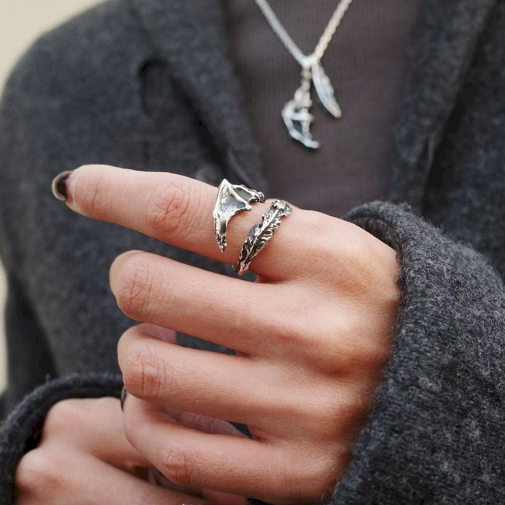 Close-up of  a set of dragon wing silver ring and necklace