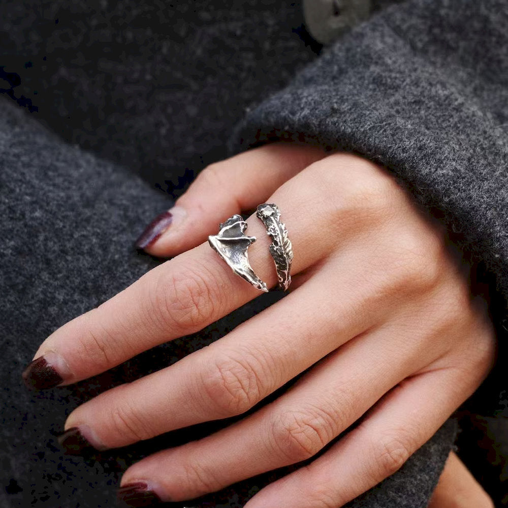 Hand wearing a Draconic Wings Ring with a detailed design