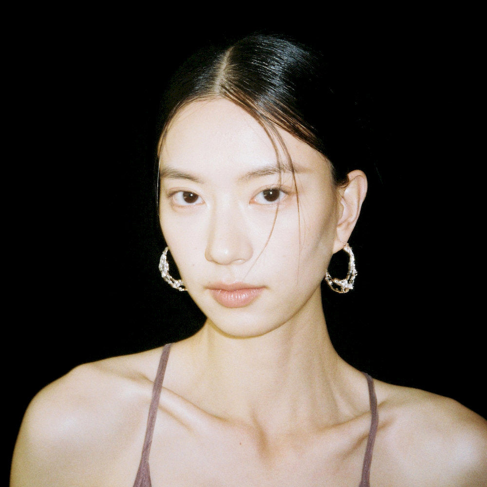 Woman wearing large hoop earrings