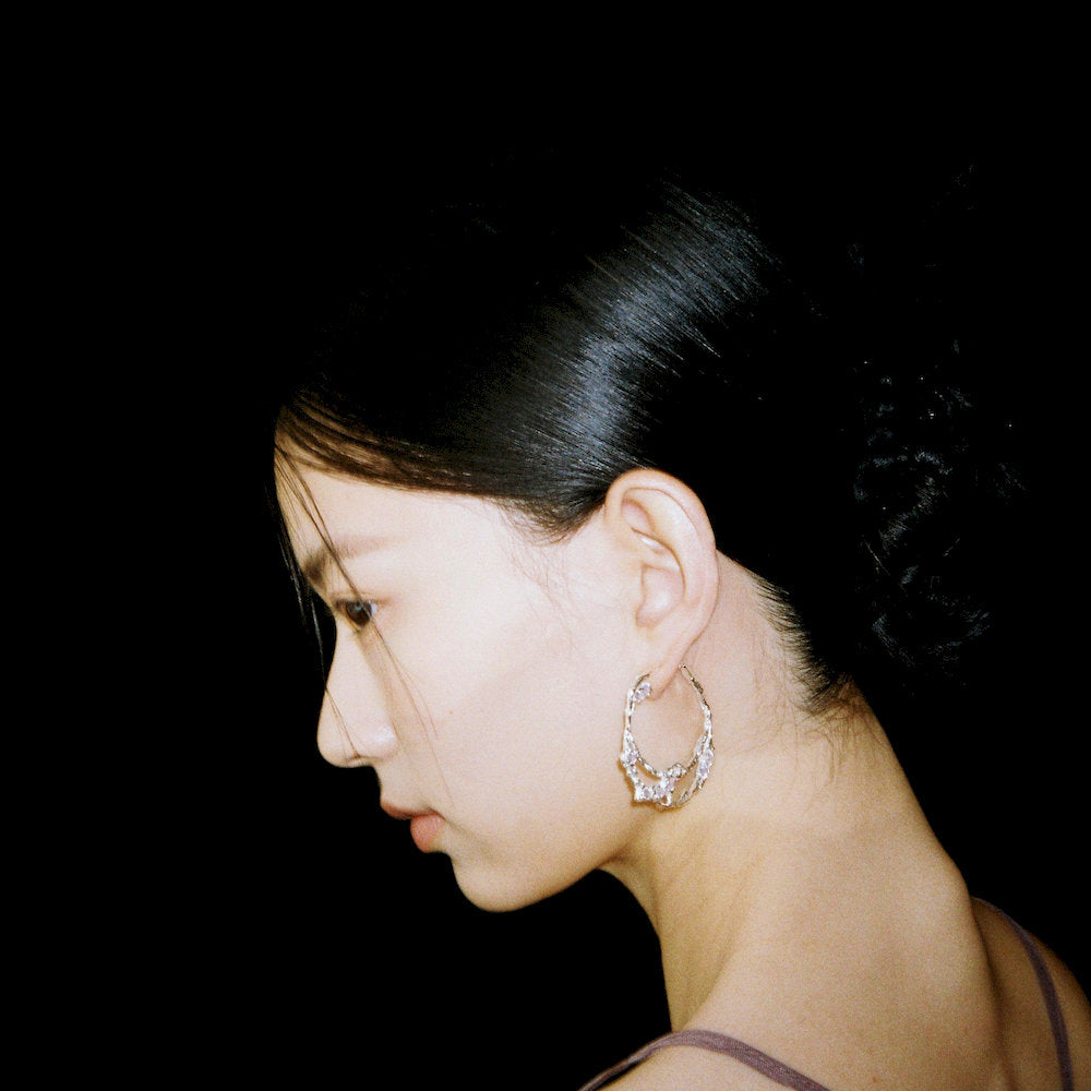 Side profile of a person wearing Luminous Ripple Earrings