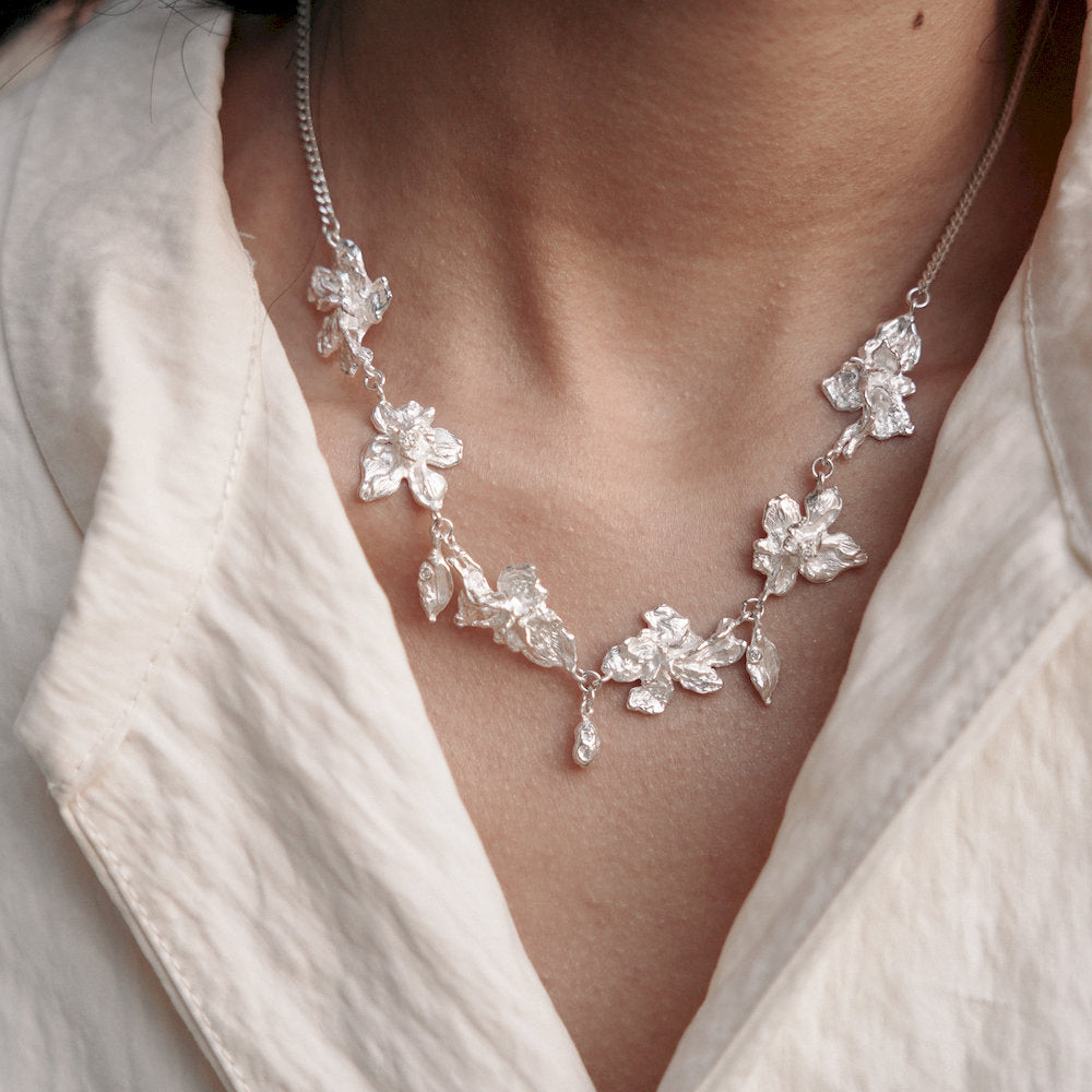 Sculptural silver floral necklace with a drop of small leaf