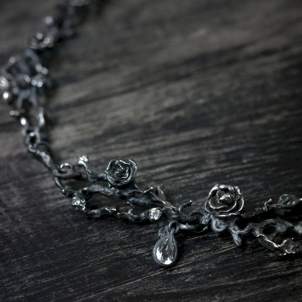 Black floral detailed necklace with a Topaz stone