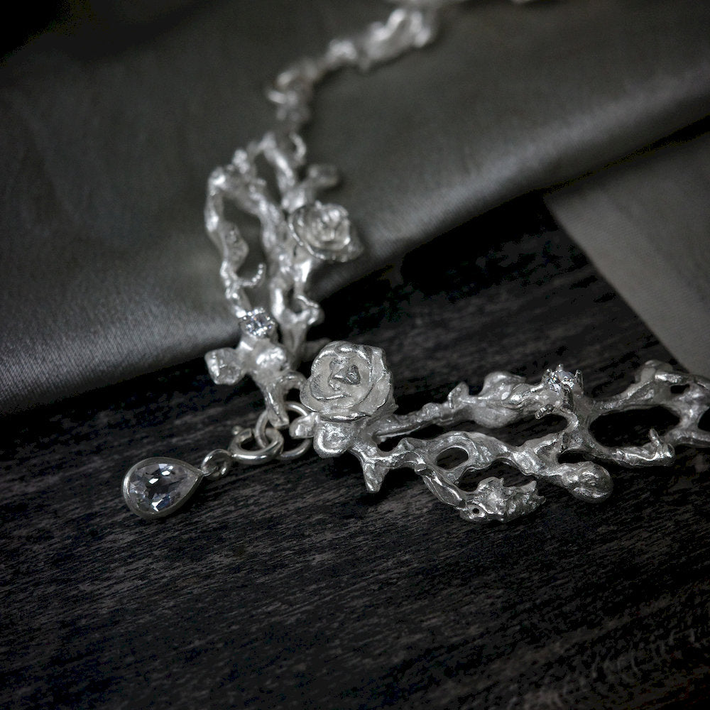 Silver floral necklace with a clear Topaz stone